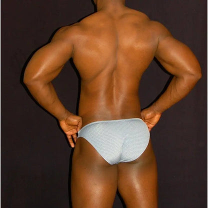 Men's bikini underwear in light blue with a checkered pattern shown from the back on a model by Arroyman.