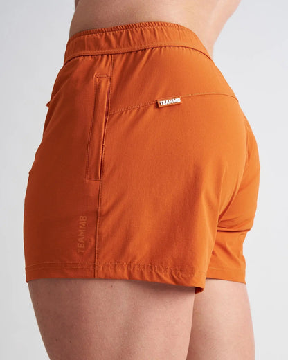 Bolt 3 inch short in orange athletic fabric with fitted waistband and side pocket for active wear