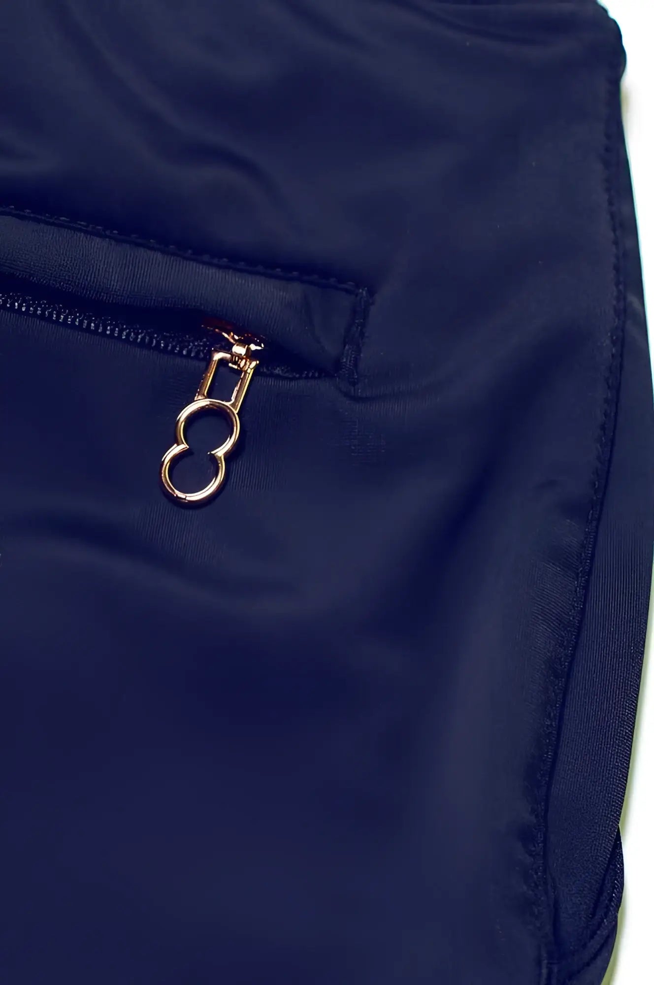 Navy blue nylon BONDI short featuring a gold-toned oval ring zipper pull for stylish and functional wear