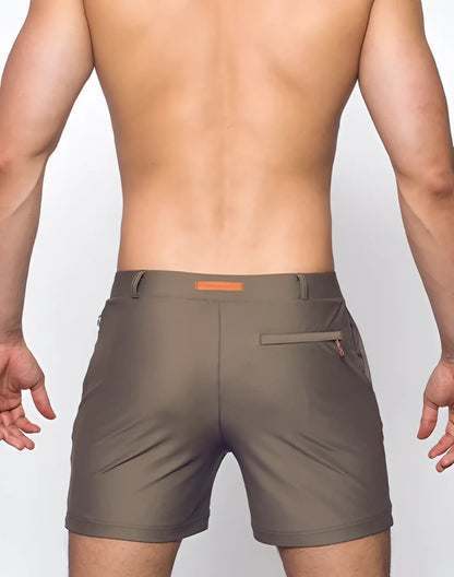 Olive green bondi shorts with subtle orange belt loop and zipper pocket detail for casual wear