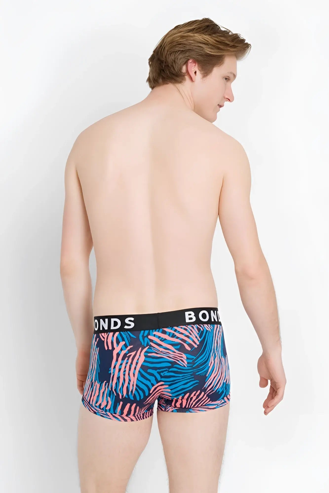 Blue and pink tropical leaf patterned bonds fit trunk boxer briefs with black waistband size xs front view