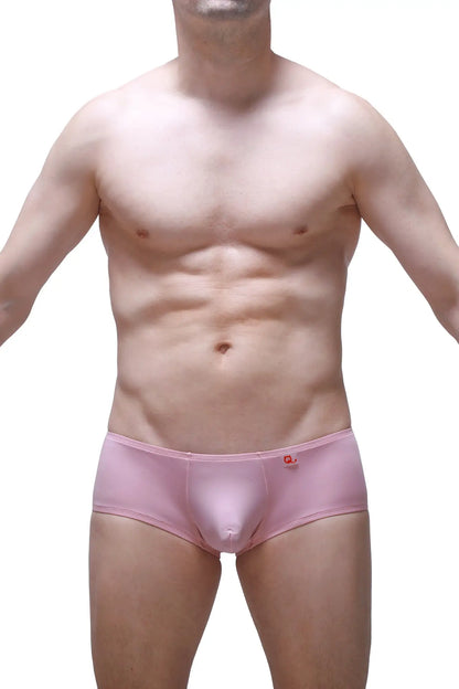 Pink men’s boxer briefs in skine tea rose with a small red logo on the waistband for comfortable everyday wear