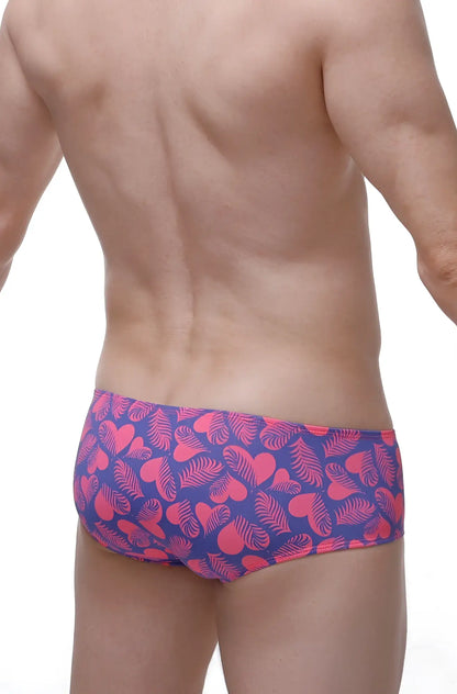 Men’s swim trunks in purple and pink with heart and leaf tropical patterns for chill beachwear