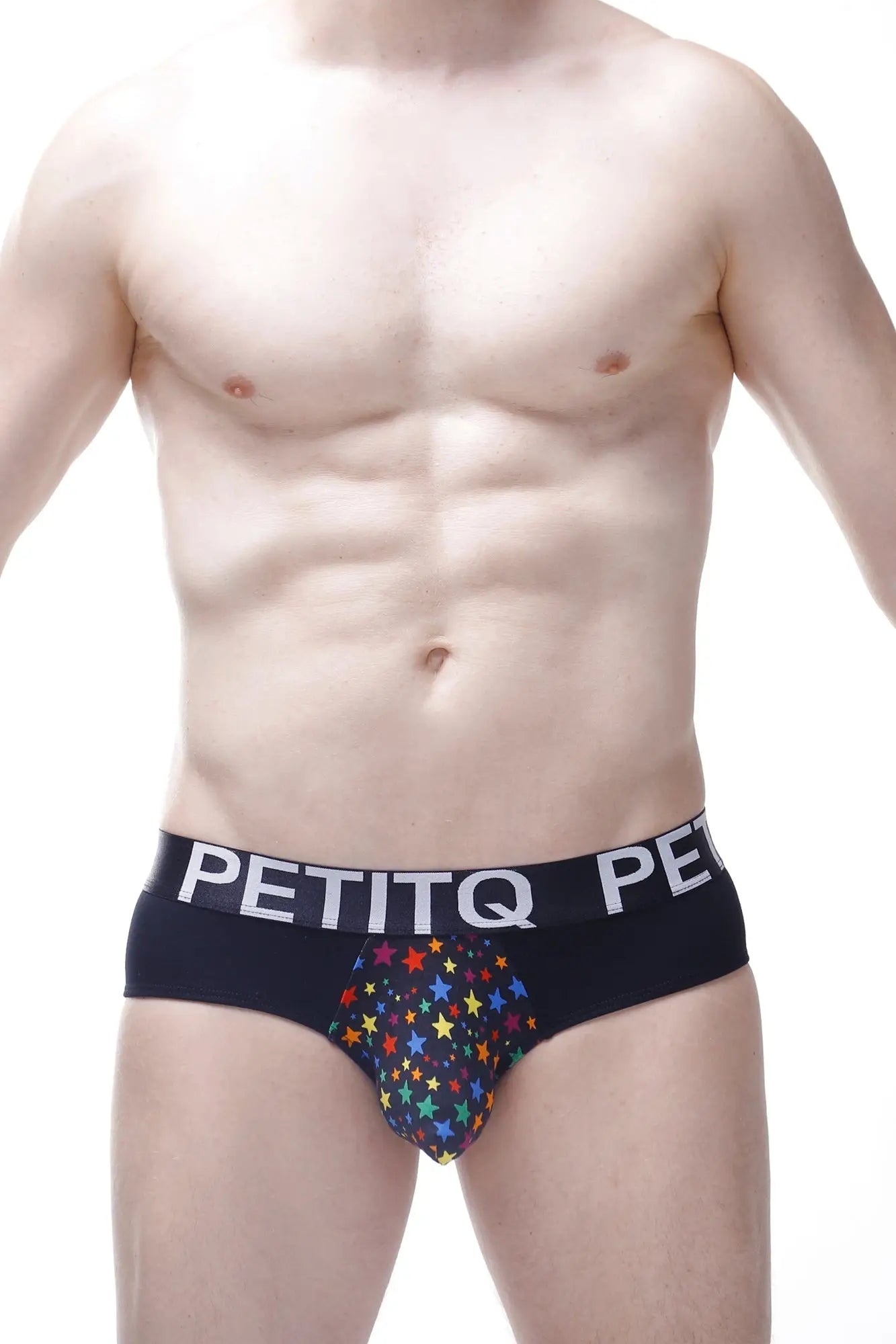 Black men’s briefs with a colorful rainbow star pattern and petitq branding on the waistband in brief stars rainbow design