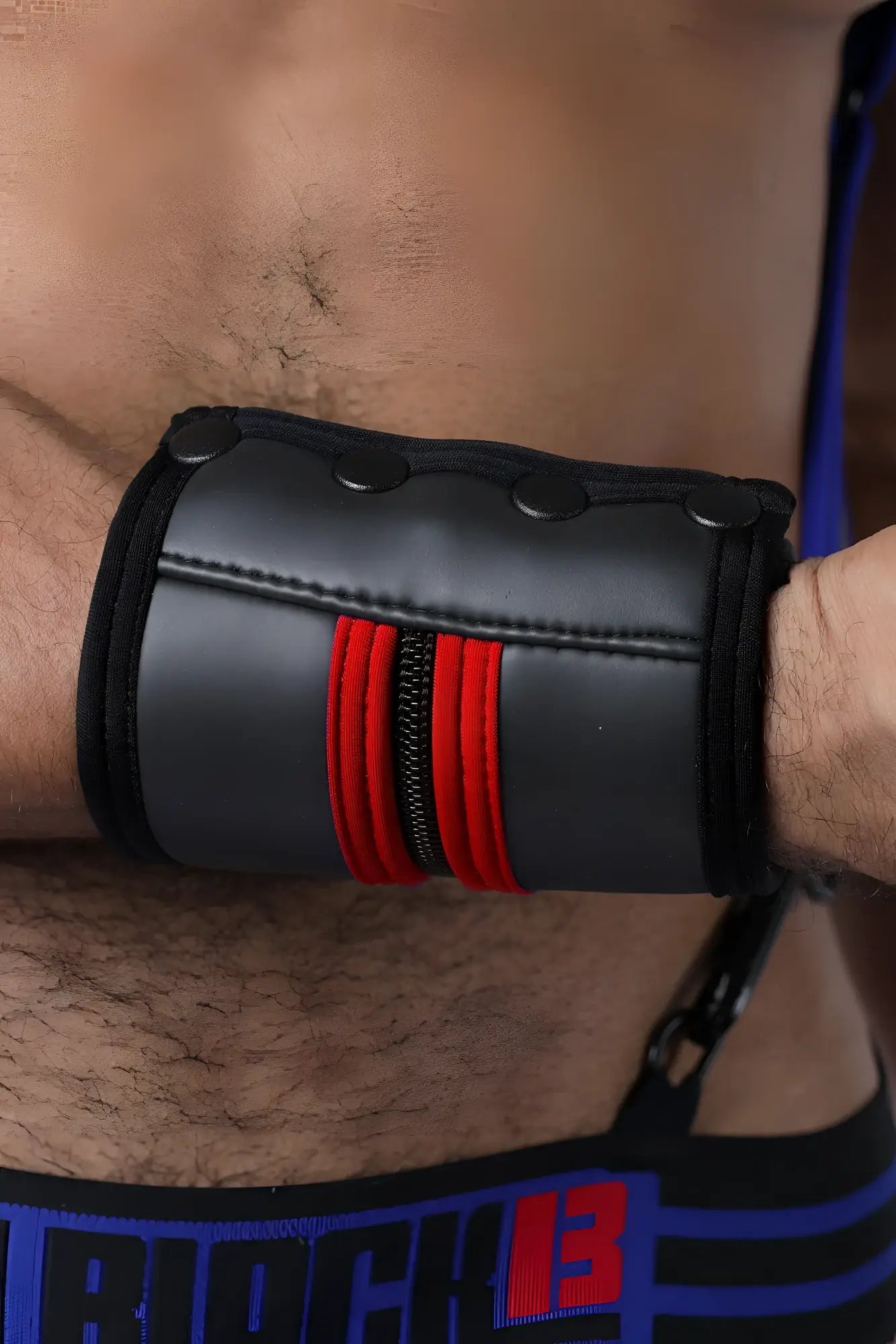 Black leather buckle up cuff wristband with red zipper accents and three black snap buttons available in 5 colors