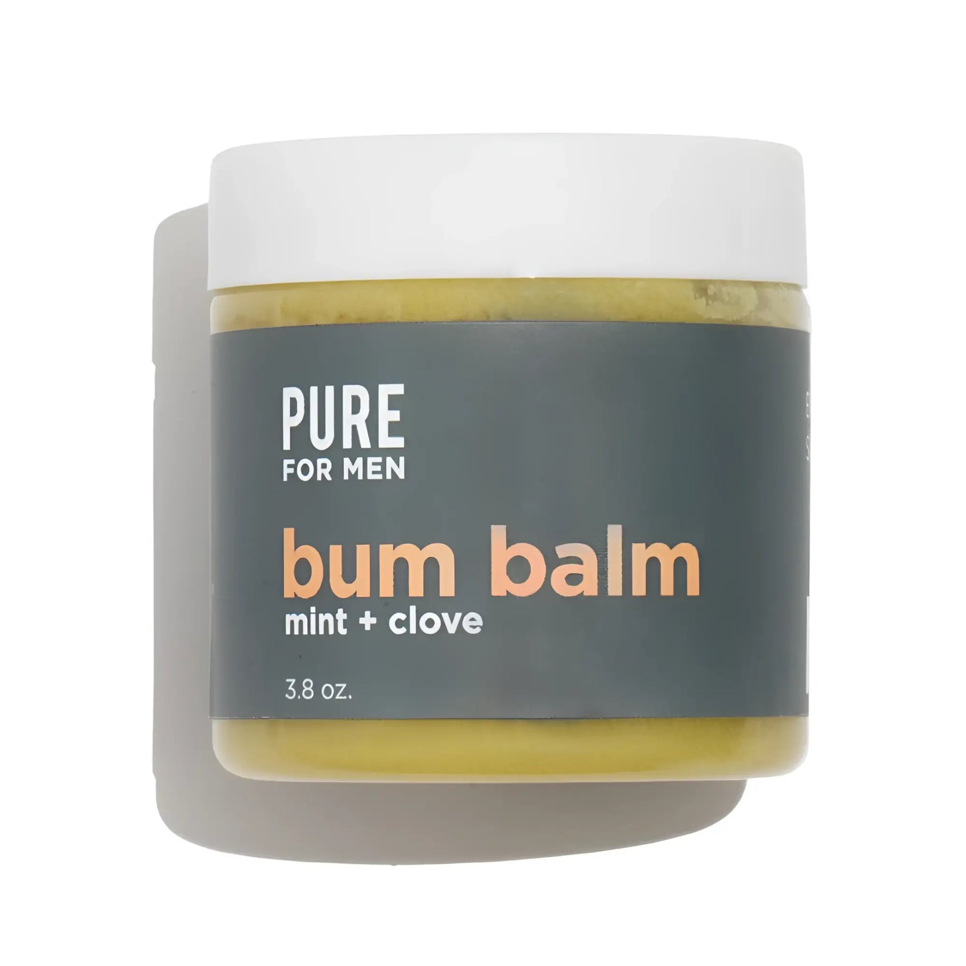 A matte white jar of pure for men bum balm mint and clove with a dark gray label and yellowish green balm inside