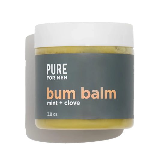 A matte white jar of pure for men bum balm mint and clove with a dark gray label and yellowish green balm inside