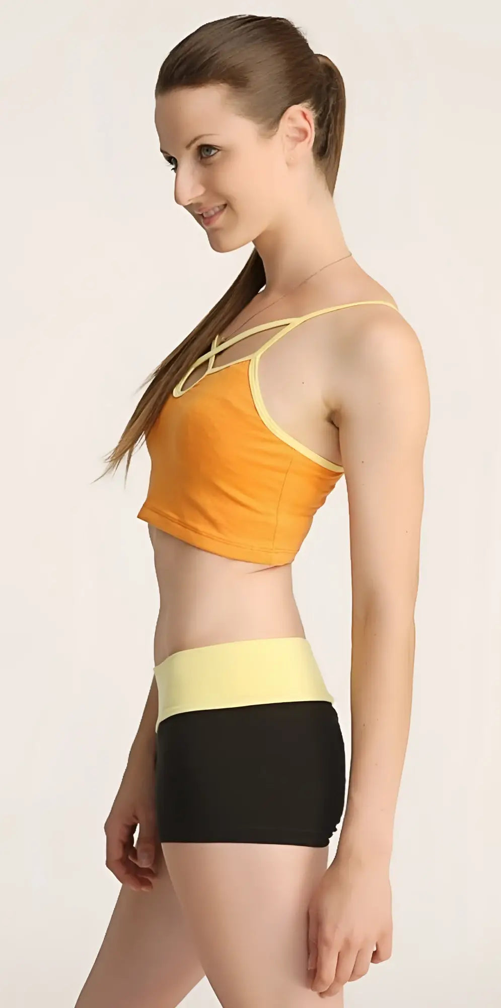 Orange and yellow cropped top with thin straps and matching high-waisted black shorts bumble short set