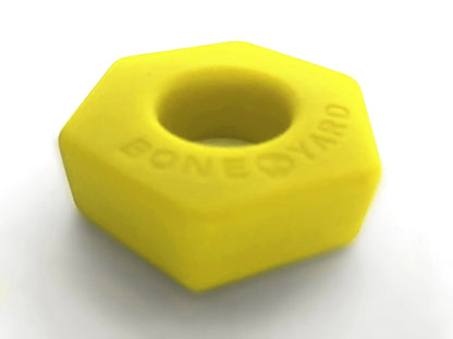 Bright yellow hexagonal silicone nut embossed with boneyard for easy grip in bust a nut product line