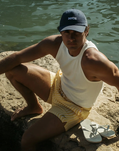 Navy blue baseball cap with white embroidered 2eros logo paired with byron swim short in dolce yellow color