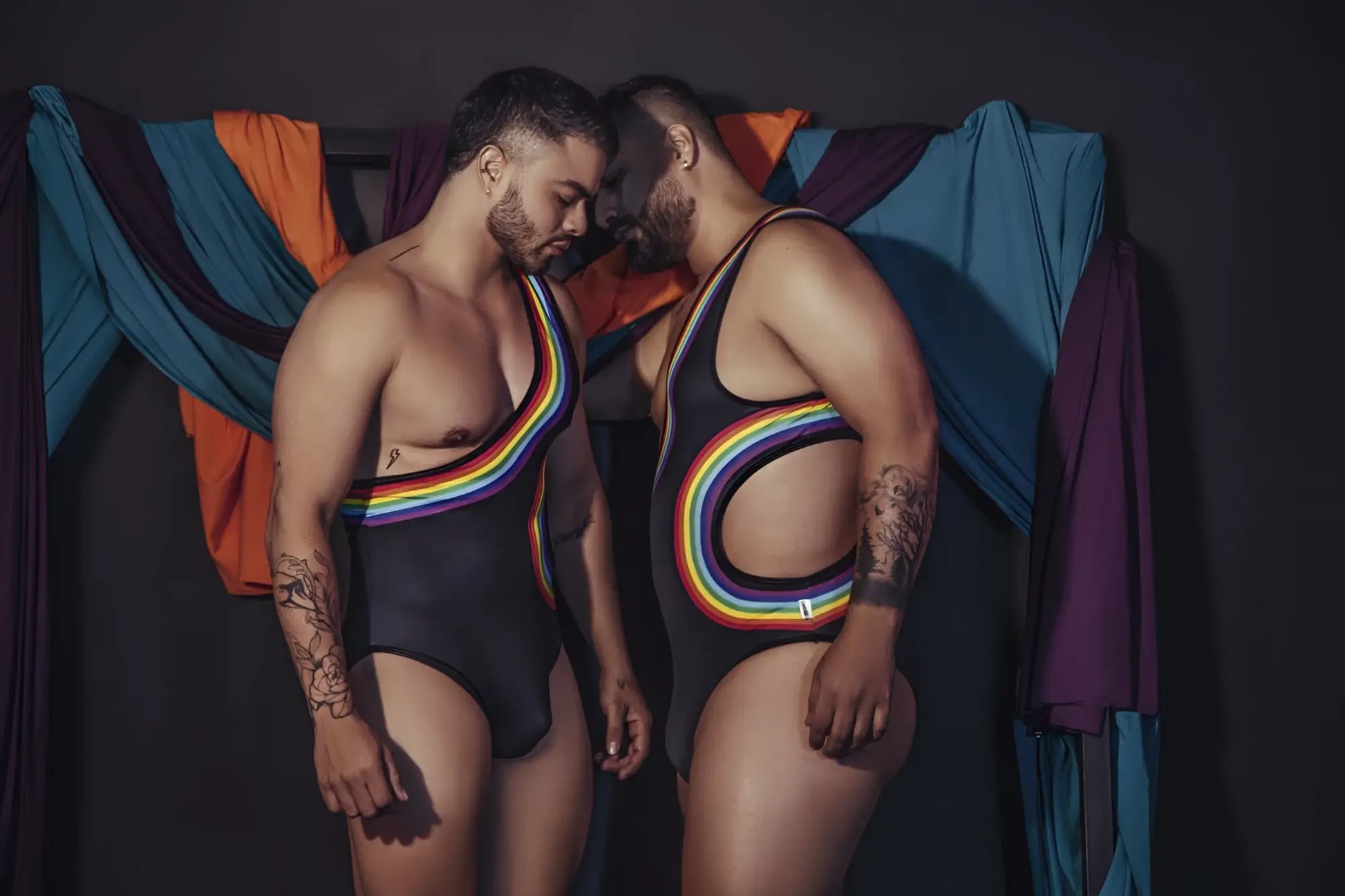 Black one-piece CandyMan 99702X bodysuit with rainbow stripes and cutouts for stylish swimwear use
