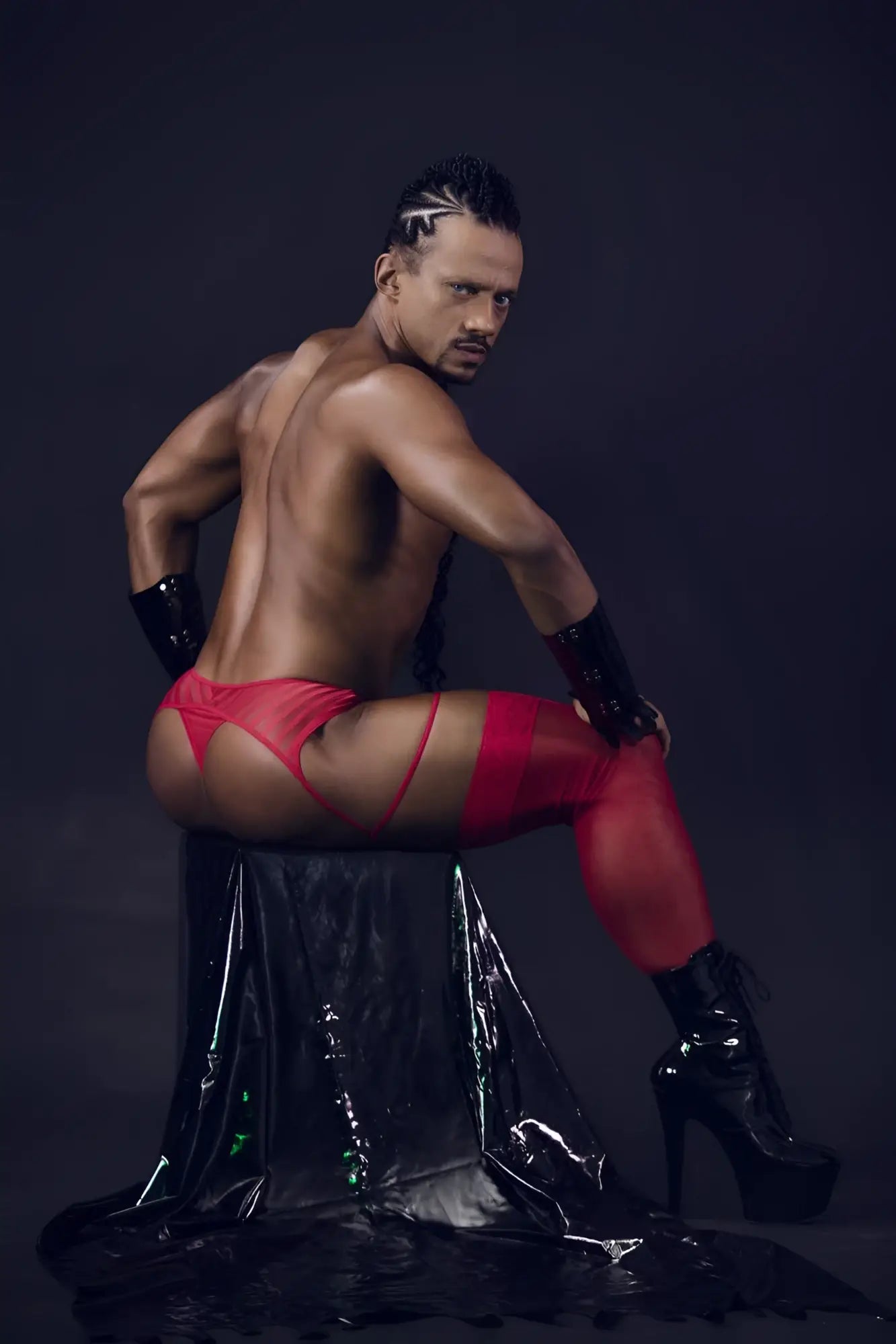 Red latex mesh garter thongs with matching arm cuffs and black high-heeled boots in candyMan 99792 color red