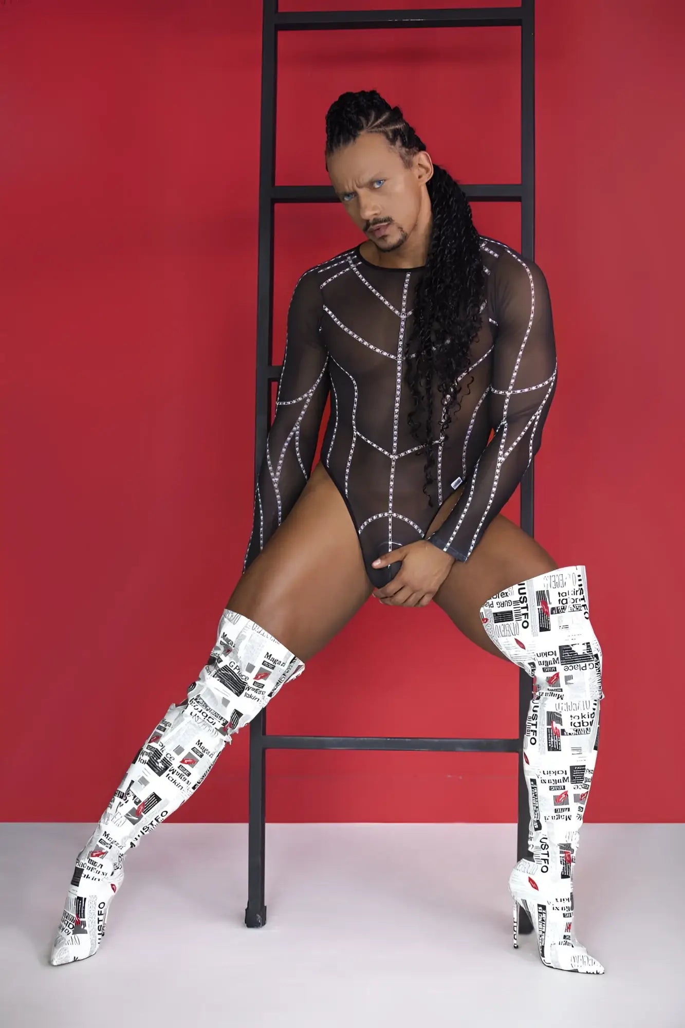 White over-the-knee boots with black text and graphics collage print paired with candyman 99816 black mesh bodysuit