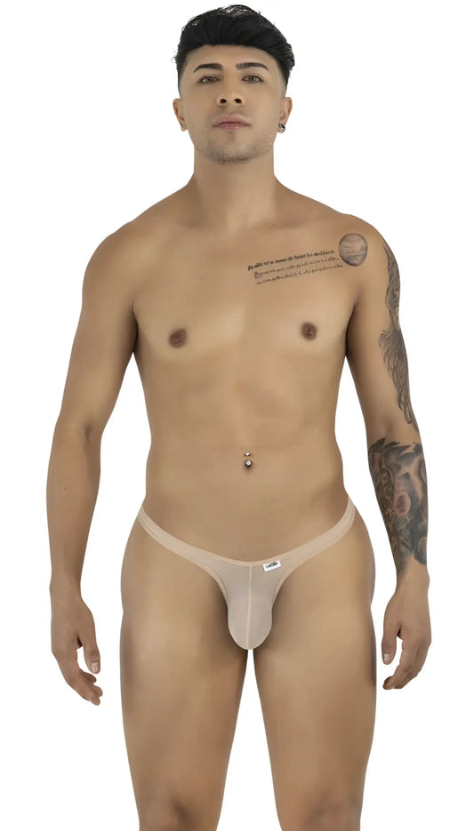 Model wearing a beige mesh CandyMan thong with a minimal cut, featuring a thin waistband and small brand label.
