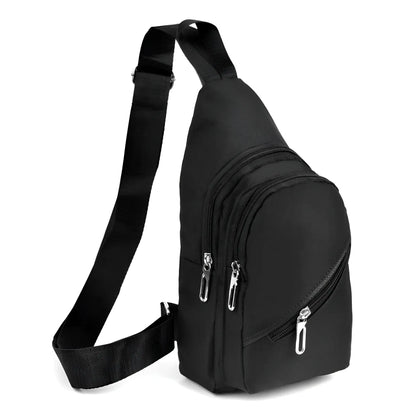 Black nylon canvas sling bag with silver zippers and adjustable crossbody strap