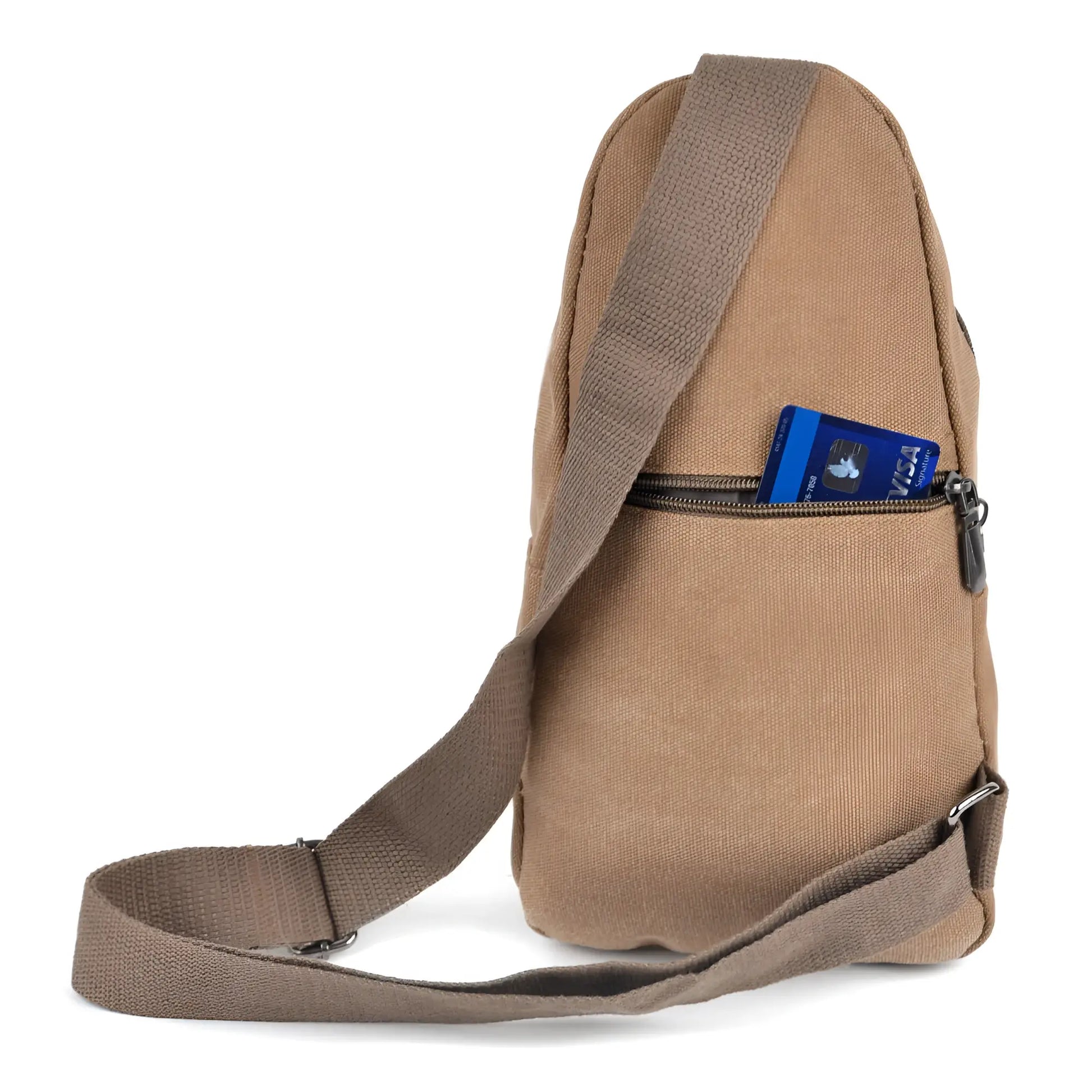 Canvas sling bag in tan with adjustable shoulder strap and front zippered pocket holding a blue visa card