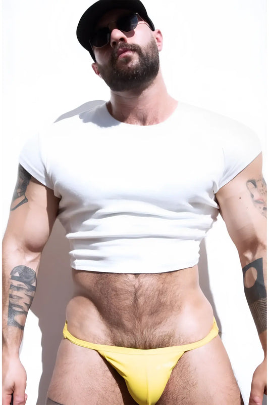Yellow thong briefs made of rib knit fabric shown from the back complementing the ivory cap sleeve crop top