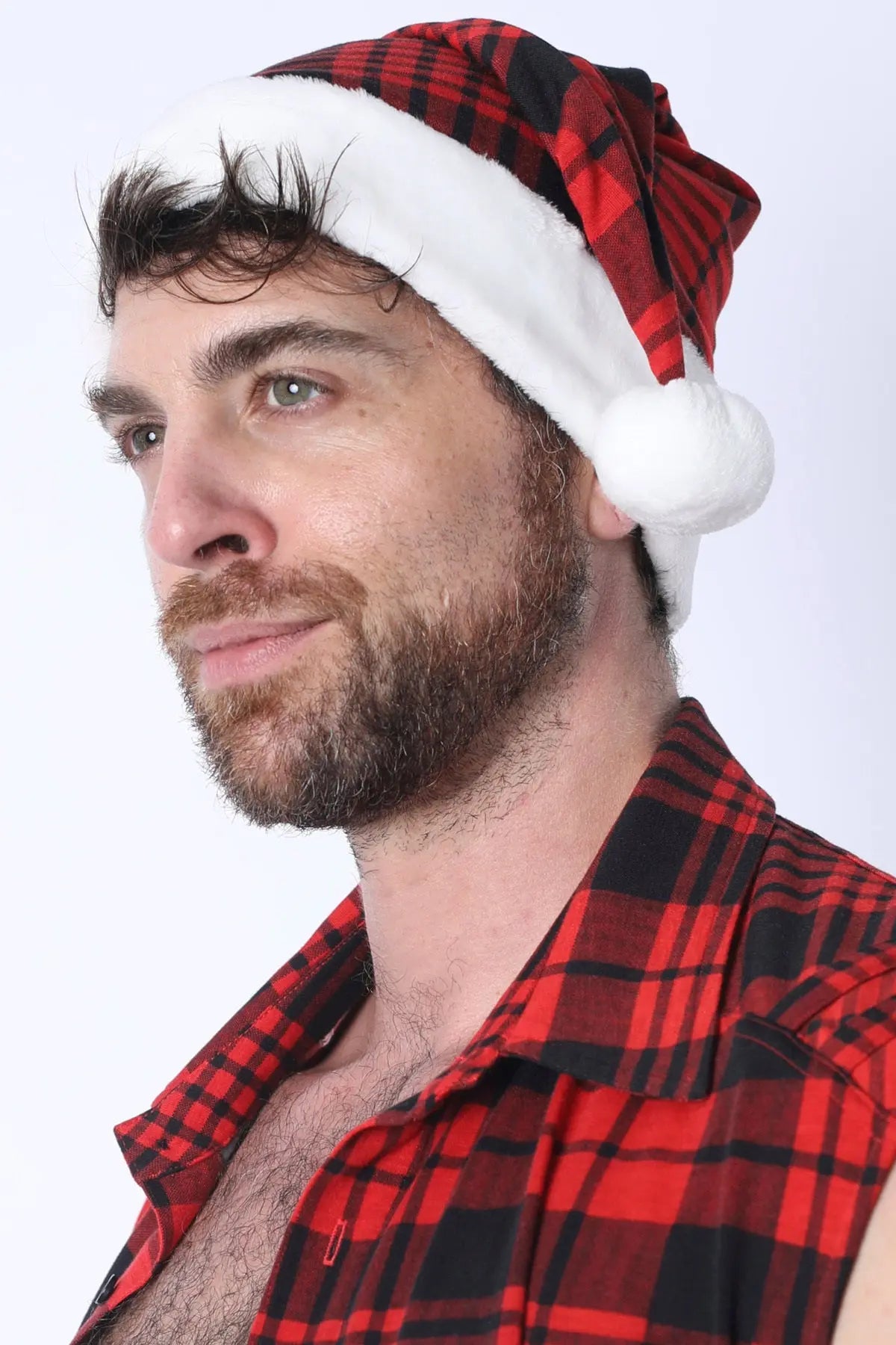 A man wearing a red plaid Santa hat with a white pom-pom styled with a matching plaid shirt by CellBlock 13