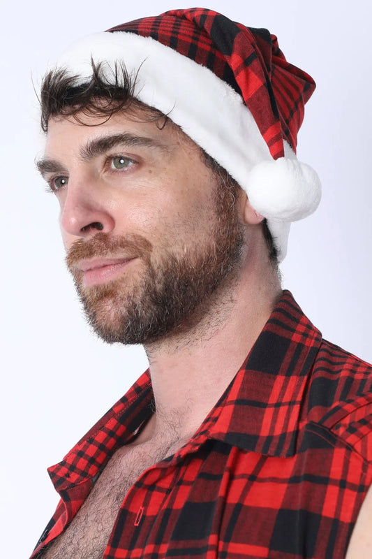 A man wearing a red plaid Santa hat with a white pom-pom styled with a matching plaid shirt by CellBlock 13