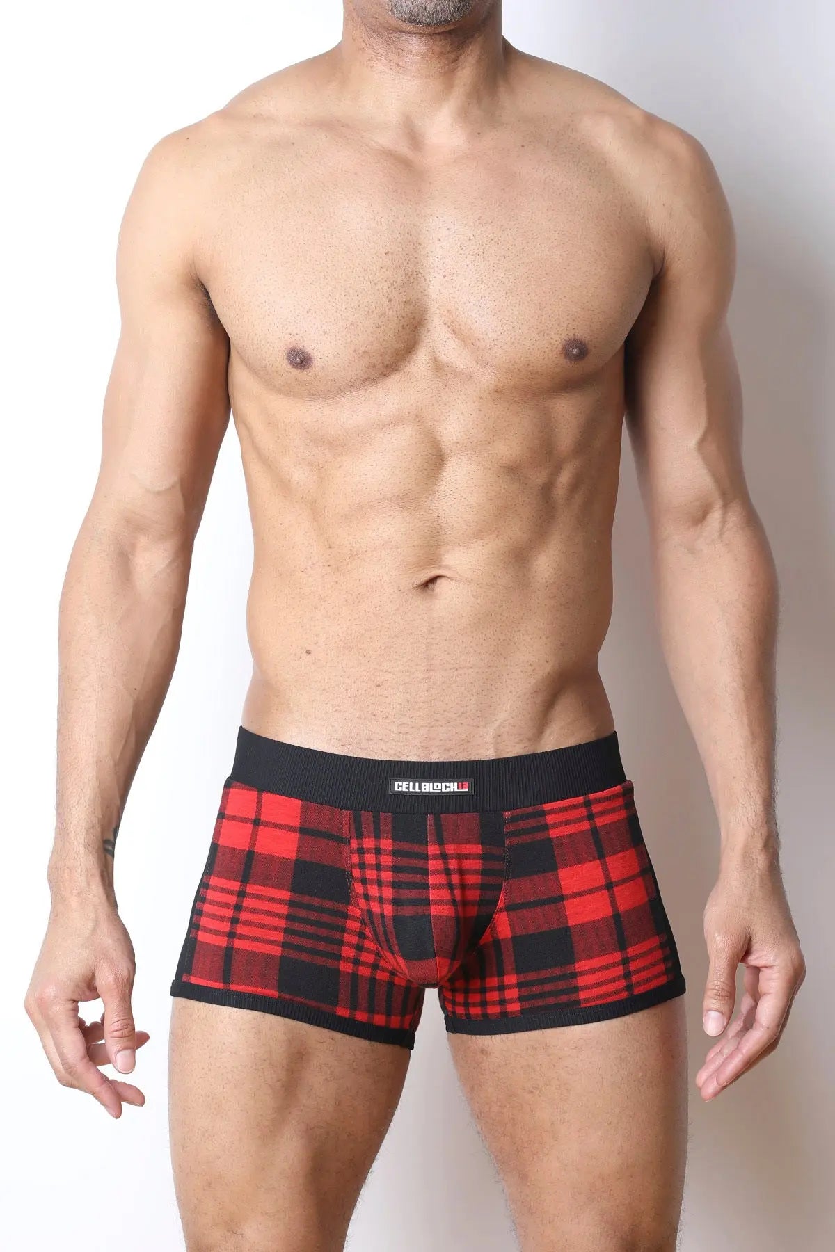 Red and black plaid trunk underwear made of soft fabric featuring a comfortable waistband modeled by a man.