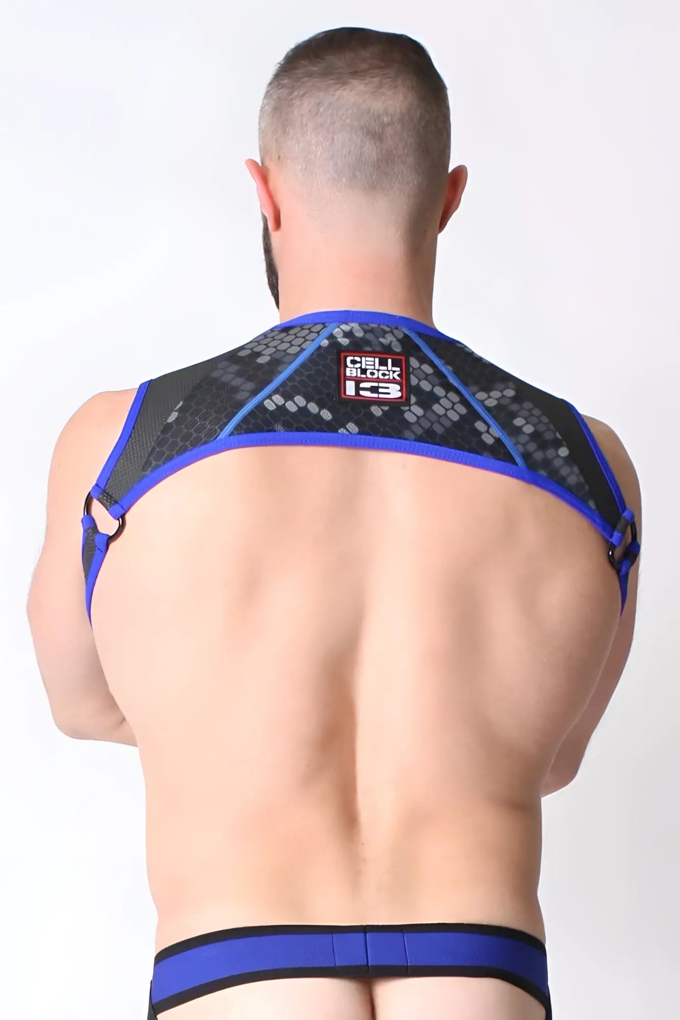 Back of cellblock 13 cyber x-treme blue l size mesh harness with black geometric pattern and cell block 13 logo
