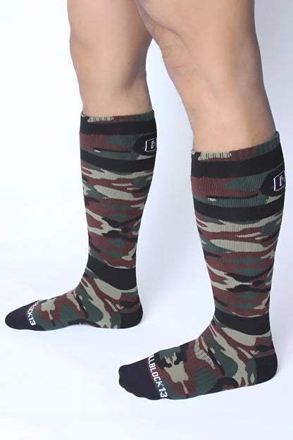 Camouflage knee-high socks with black ribbed cuffs and toe caps in green brown and beige tones by cellblock 13