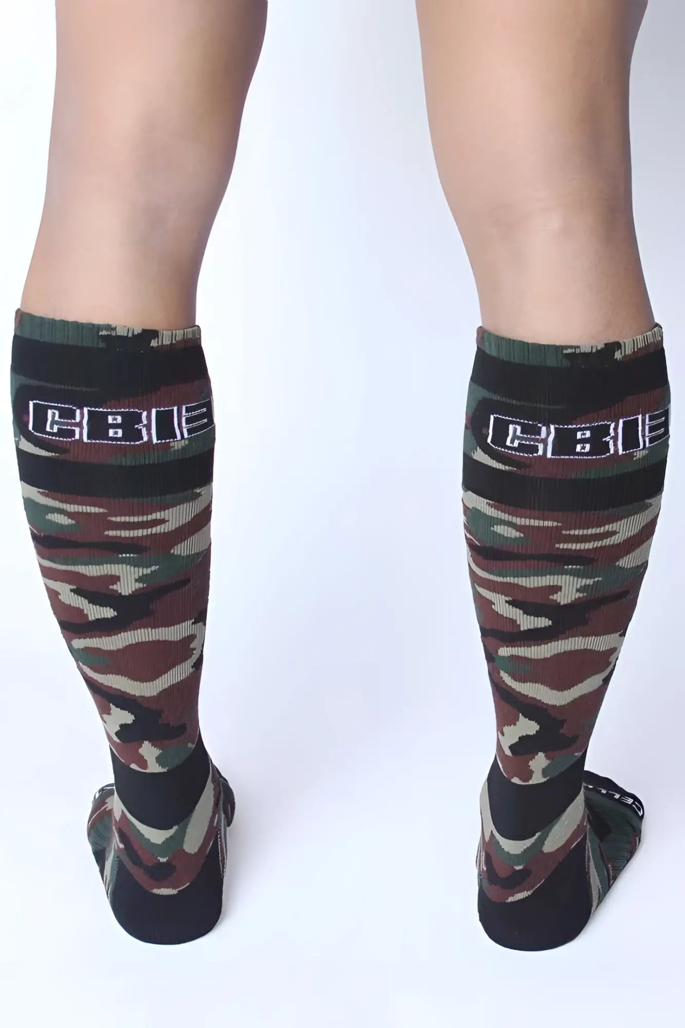 Camouflage pattern knee-high socks with black ribbed cuff featuring cbi logo green one size cellblock 13 foxhole socks