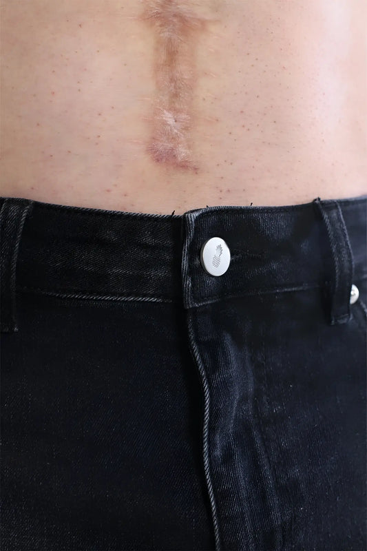 A subtle pineapple design white button fastened on dark denim cheeky summer 2.5 inch brief shorts black