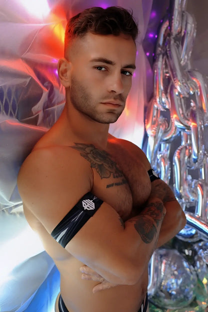 Black and white striped circuit breaker armband with small logo on upper arm made of durable fabric for safety identification