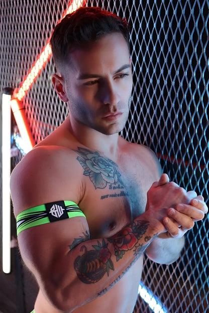 Neon green and black striped circuit breaker armband with central logo patch made of durable fabric for sports use