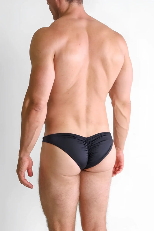 Black ruched swim trunks showing the back side of classic scrunch-butt swim briefs for comfortable beachwear