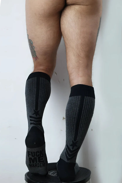 Black and gray cockpit socks with bold black star design and reinforced toe caps for athletic compression use