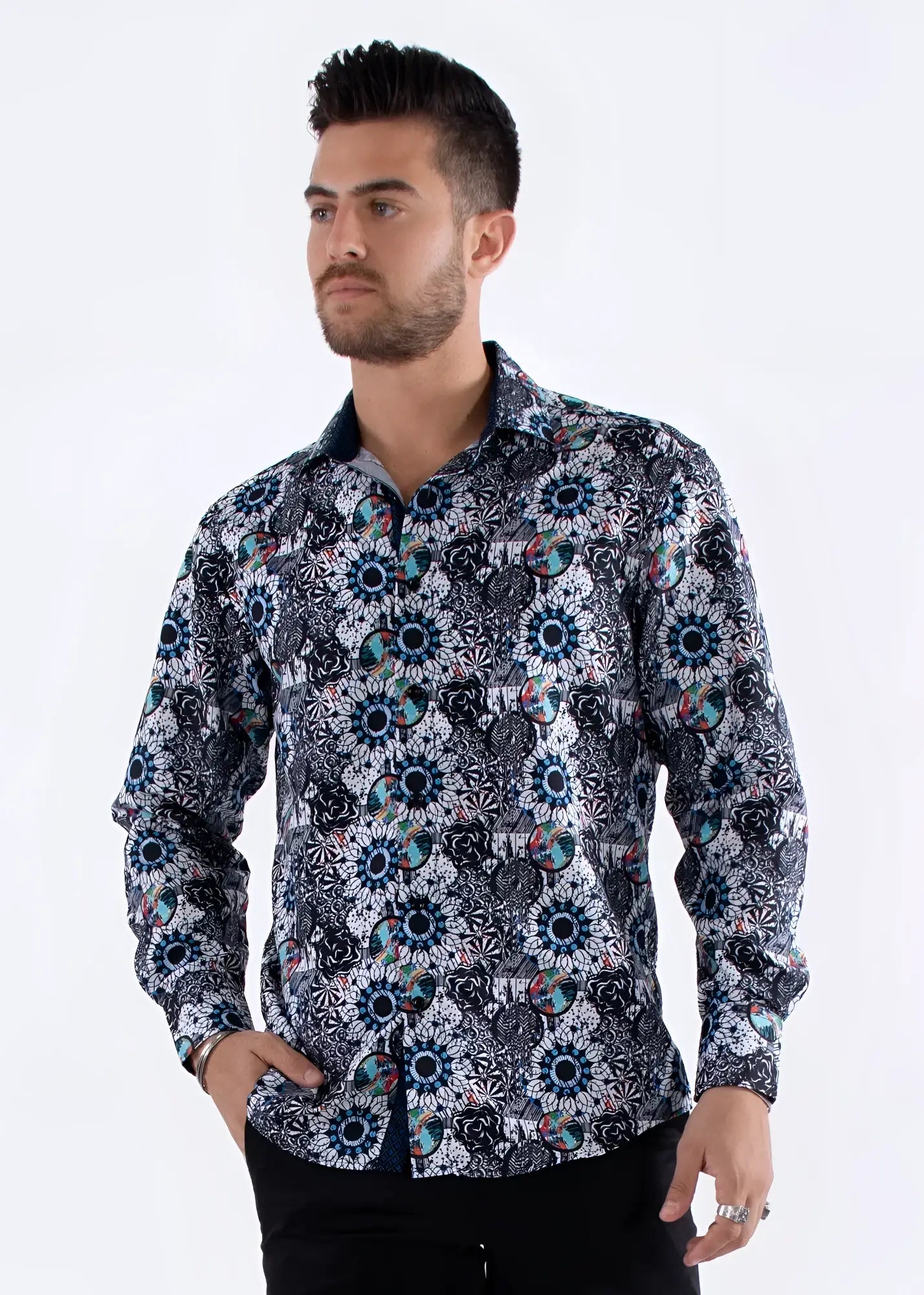 A men’s long-sleeved button-up shirt with bold geometric and floral patterns in navy blue teal black white and pink