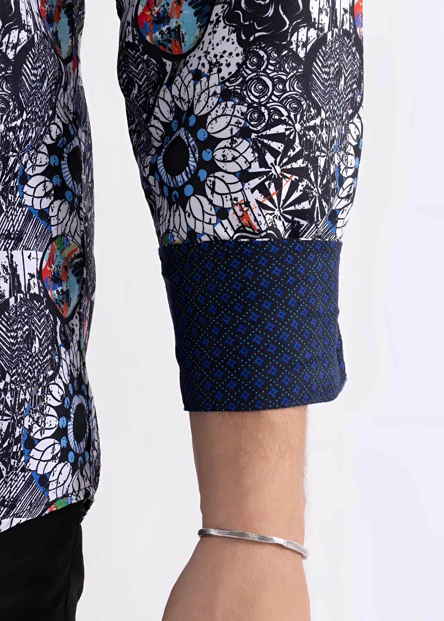 Colored shapes print l/s shirt sleeve with bold black white pattern and blue orange splashes and navy cuff with geometric design