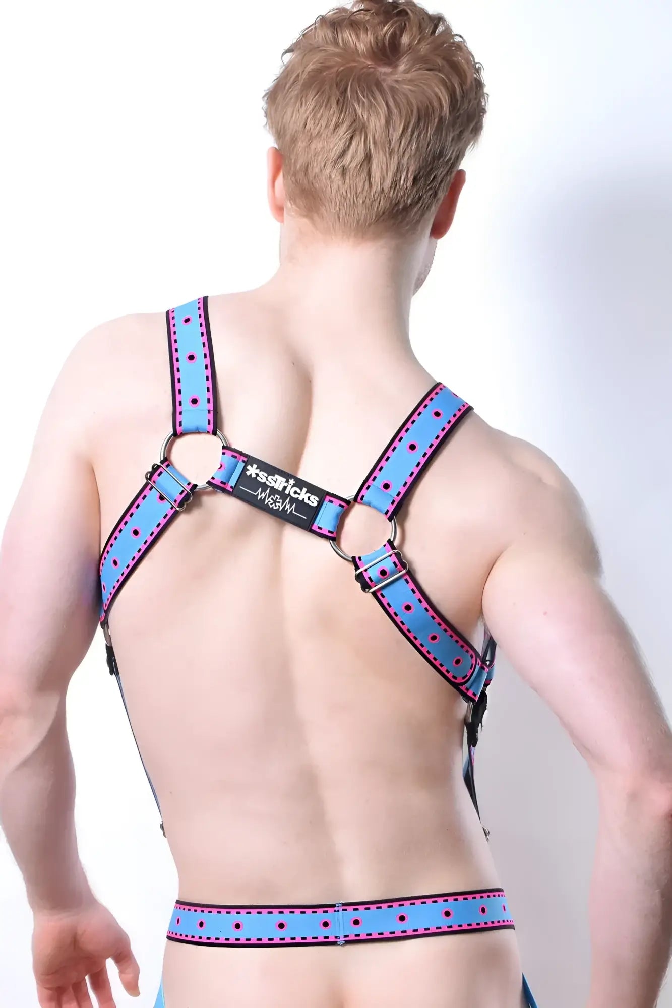 Blue polka-dotted leather comicaze harness with black metal rings and branded label visible on the front side