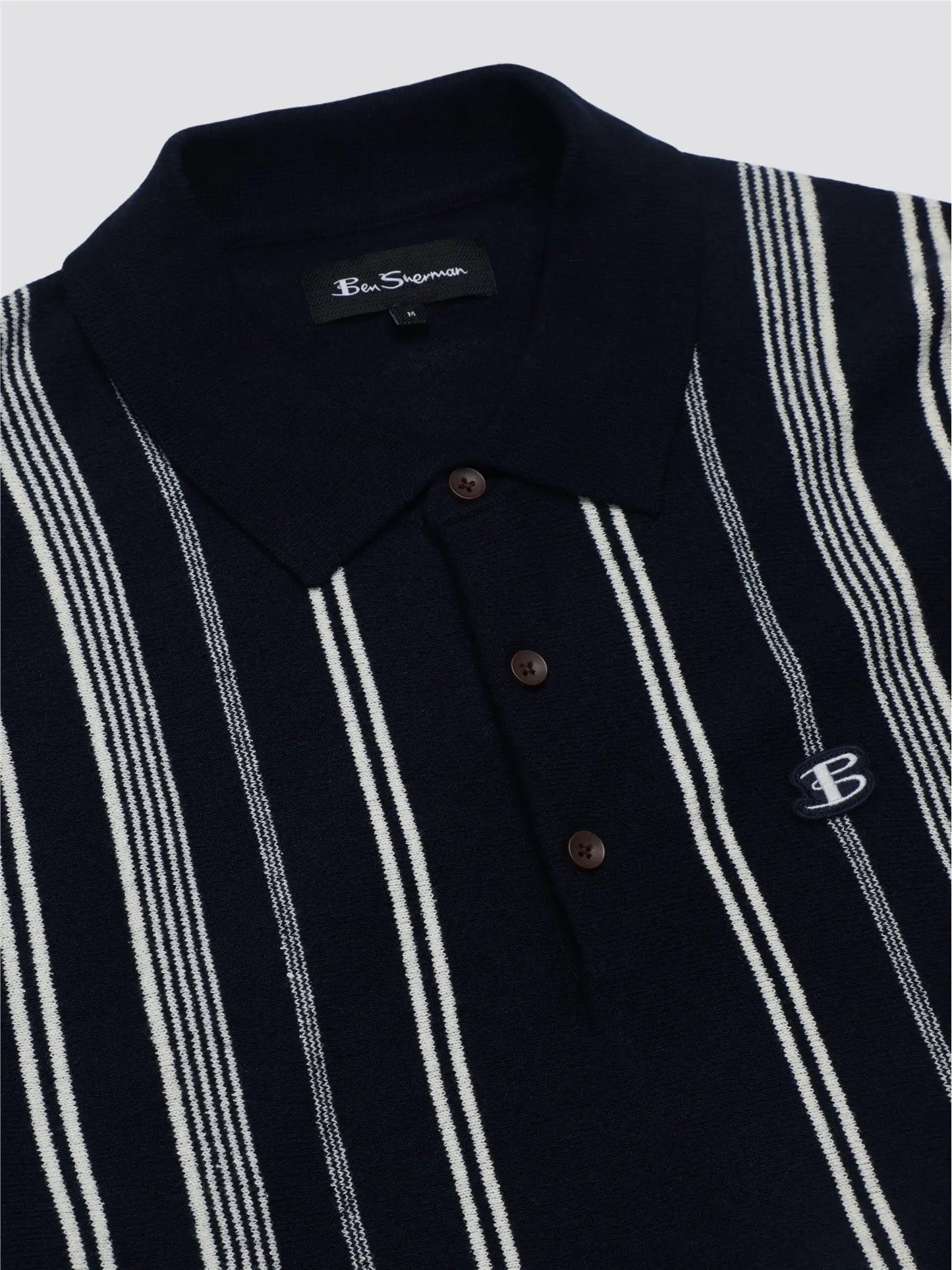 Navy blue and white striped crinkle cotton polo shirt with a small embroidered logo on the chest
