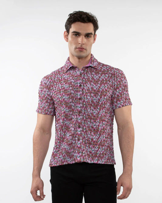 A man wearing a vibrant pink and white crinkle knit short sleeve shirt with a floral pattern