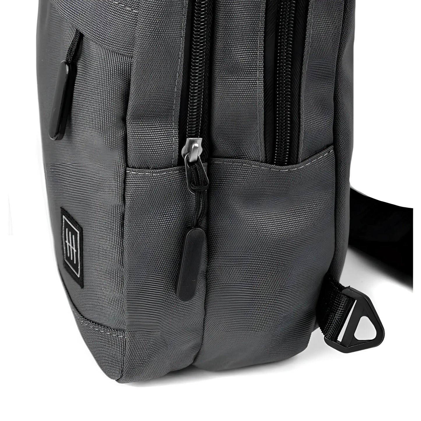 Dark gray canvas crossbody sling bag with black zippers and small square logo patch for everyday use