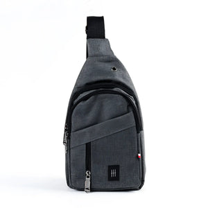 Gray textured fabric crossbody sling bag with black zipper pulls and small black logo patch for everyday use