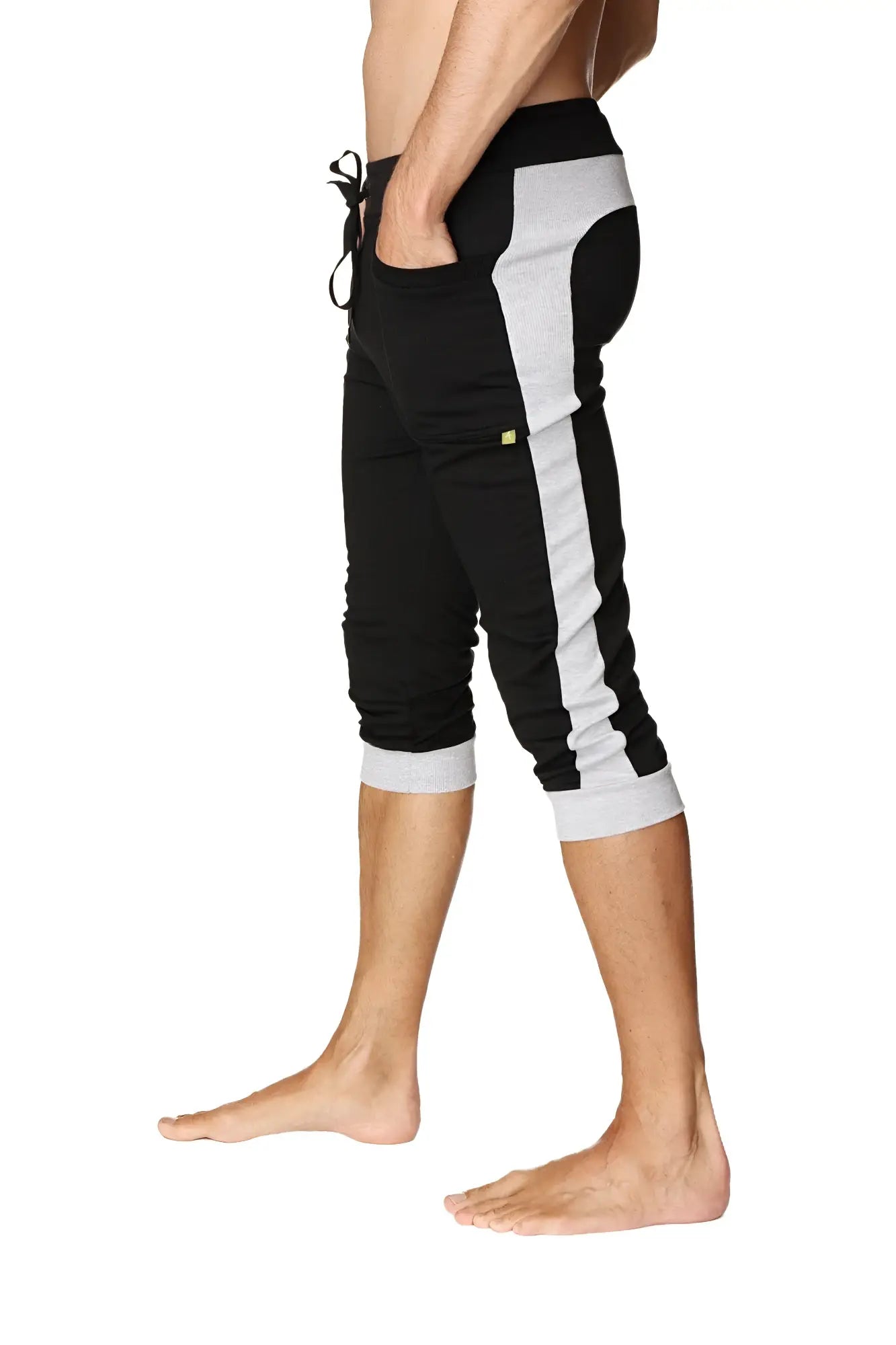 Black and gray cuffed yoga pants with side stripe elastic waistband and rolled cuffs designed for athletic wear