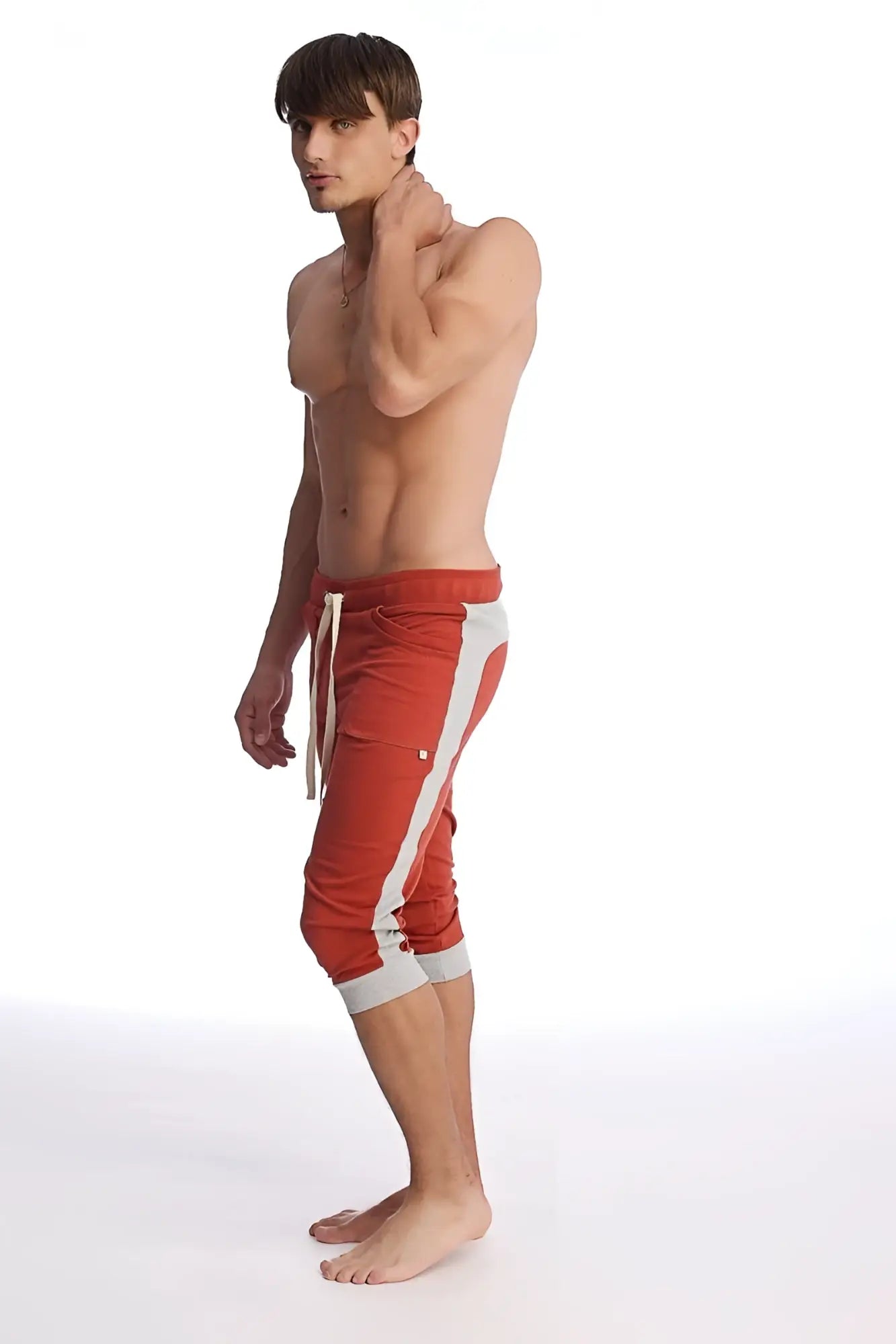 Cuffed yoga pants in cinnabar with grey featuring red athletic capri style, white side stripes, and matching drawstring waistband