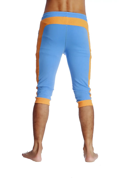 Cuffed yoga pants in ice blue with orange featuring ribbed waistband and cuffs for comfortable athletic wear