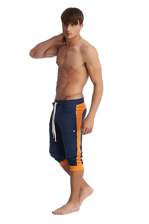 Cuffed yoga pants in royal blue and orange with white drawstring designed for athletic comfort and flexibility