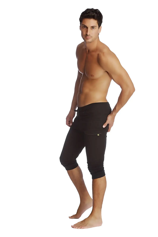 Black cuffed yoga pants with snug fit and subtle side pocket detailing in capri-length athletic style