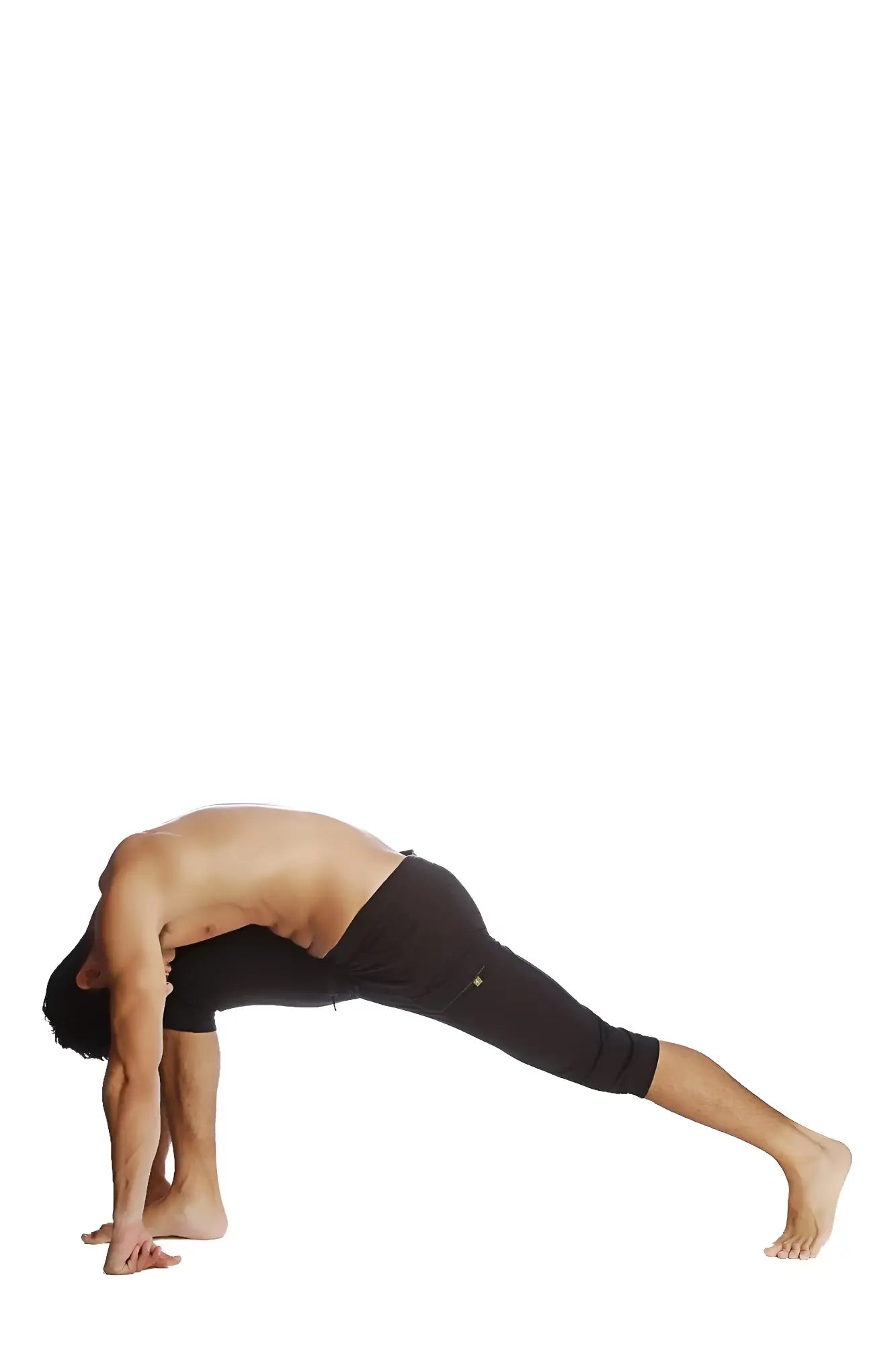 A man in solid black cuffed yoga pants made of stretchy material performs a yoga pose against a white background