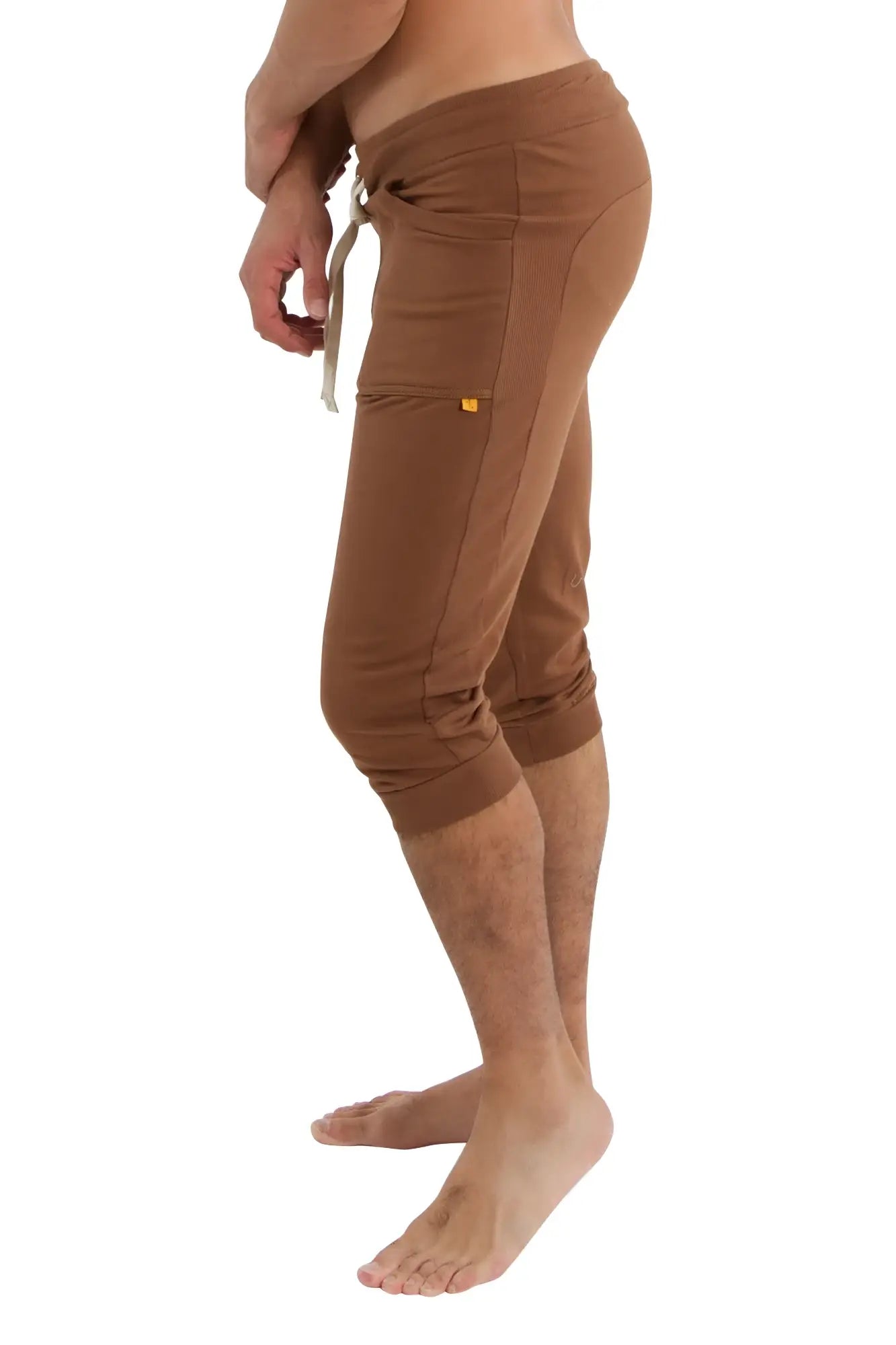 Brown cuffed yoga pants with drawstring waistband and side pockets designed for athletic and casual wear