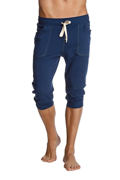 Navy blue cuffed yoga pants with white drawstring and stitched pockets made of soft fabric for comfortable workouts