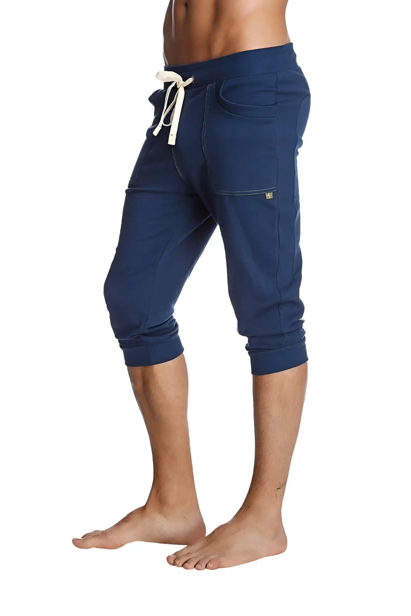 Navy blue cuffed yoga pants with white drawstring cropped jogger style and side pockets for comfortable wear