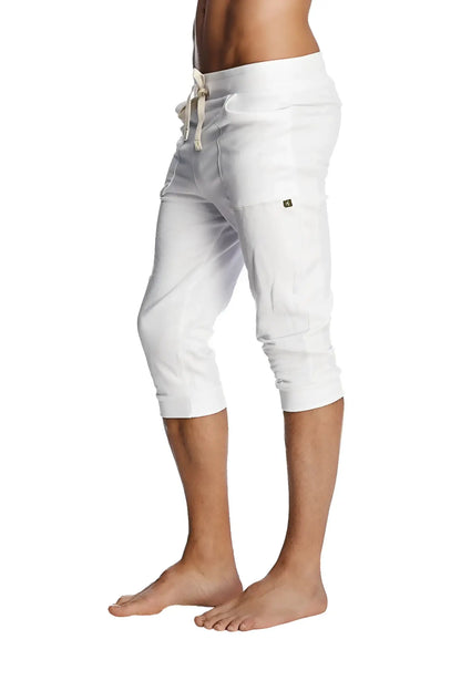 White capri-length cuffed yoga pants with drawstring waistband and subtle side pockets for comfortable wear