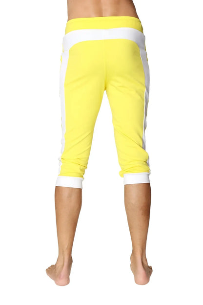 Bright yellow cuffed yoga pants with white side stripes and elastic waistband for comfortable activewear